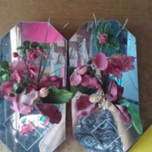 VINTAGE PAIR MIRRORS WITH FLOWERS ATTACHED.